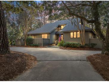 Charming single-Gathering home featuring a private driveway and an inviting, landscaped front yard at 385 Green Winged Teal Rd, Kiawah Island, SC 29455
