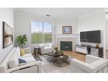 Bright living room with a fireplace, large window, and modern furnishings at 130 River Landing Dr # 7309, Charleston, SC 29492