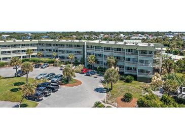 Condominium complex featuring ample parking and mature landscaping, offering convenient coastal living at 1300 Ocean Blvd # 102 A, Isle of Palms, SC 29451