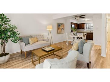 Bright living room features modern decor, light wood floors, and an open floor plan at 2362 Parsonage Rd # 17G, Charleston, SC 29414