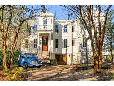 Charming two-story home with landscaped yard, front stairs, garage and a blue Moke at 26 Saturday Rd, Mount Pleasant, SC 29464