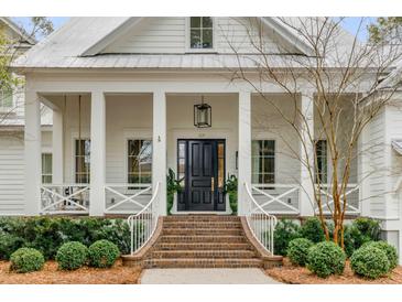 Inviting front entrance with classic black door, brick steps, white railings and manicured landscaping at 309 N Civitas St, Mount Pleasant, SC 29464