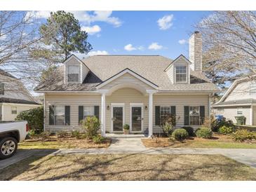 Charming townhouse exterior with neutral siding, dormer windows, covered entry and well-maintained landscaping at 4850 Habersham Ln, Summerville, SC 29485