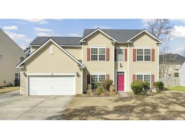 Charming two-story home boasts a well-maintained front yard and a two car garage at 9620 Pebble Creek Blvd, Summerville, SC 29485