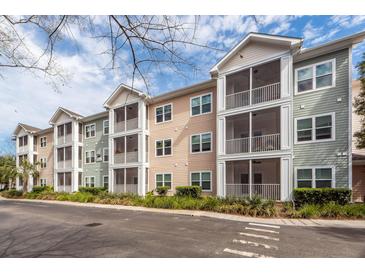 Charming apartment building with screened porches and well-maintained landscaping under a partly cloudy sky at 1755 Central Park Rd # 5107, Charleston, SC 29412