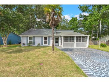 Charming single-story home featuring a screened porch and unique patterned driveway at 204 Tram Blvd, Summerville, SC 29486