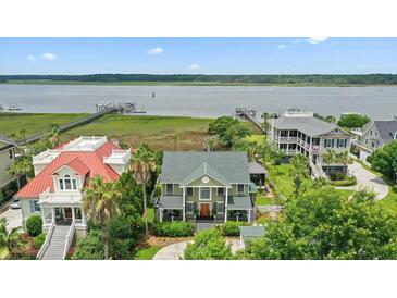 Stunning waterfront home with a green roof, lush landscaping, and neighborhood docks at 2156 Cheswick Ln, Mount Pleasant, SC 29466