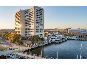 Tall waterfront building with a pier in Charleston, South Carolina, glistening in the early morning light at 330 Concord St # 14 A, Charleston, SC 29401
