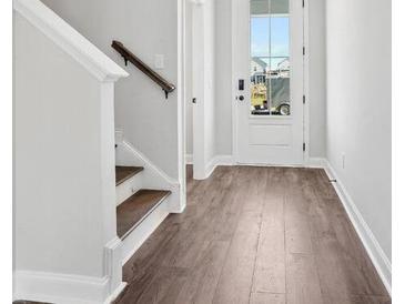 Inviting entryway featuring wood flooring and a staircase with white trim at 365 Chapman Cir, Goose Creek, SC 29445