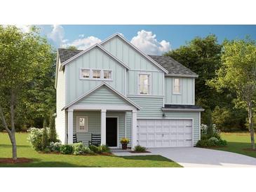 Charming two-story home featuring a covered entry, an attached two car garage, and professionally landscaped yard at 605 Red Monarch Way, Moncks Corner, SC 29461