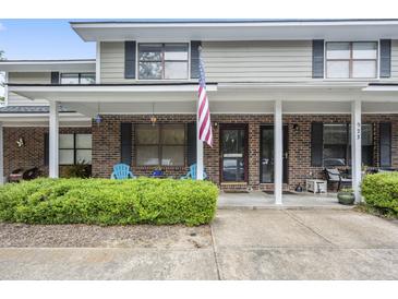 Charming brick townhouse with an American flag and a well-manicured front yard at 925 Dills Bluff Rd # 34, Charleston, SC 29412