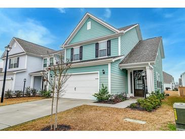 Charming two-story home with attached garage, manicured lawn, and welcoming entryway at 109 Forest Springs Rd, Moncks Corner, SC 29461