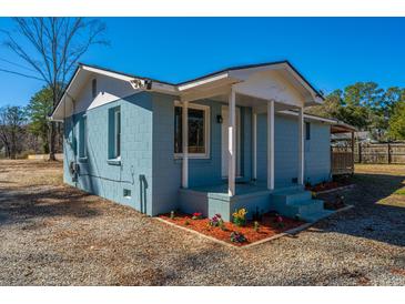 Charming bungalow with a cozy porch and a colorful flower bed at 117 Roberts Rd, Summerville, SC 29483