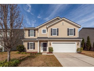 Charming two-story home featuring a manicured lawn, attached two-car garage and classic curb appeal at 426 Mountain Laurel Cir, Goose Creek, SC 29445