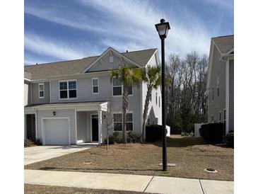 Charming home with gray siding, well-manicured lawn, and palm trees in the front yard at 618 Hilchot Dr, Summerville, SC 29486