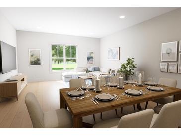 Bright dining area features wood table set for a meal and lots of natural light at 7626 Indigo Palms Way, Johns Island, SC 29455