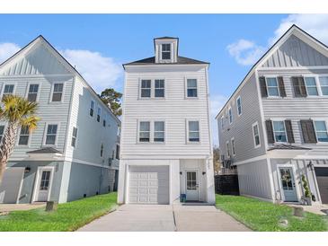 Charming three-story home with a one car garage and a well-manicured lawn in a friendly neighborhood at 1002 Carmela Ct, North Charleston, SC 29405