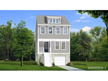 Charming three-story home with a gray exterior, white trim, a front-facing garage, and well-manicured landscaping at 1082 Glenshaw St, North Charleston, SC 29405