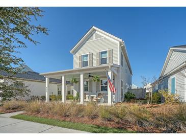 Charming two-story home featuring a inviting front porch with traditional design elements and a well-manicured lawn at 142 Midtown Ave, Summerville, SC 29486