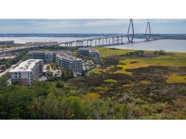 Stunning aerial view of a waterfront condominium complex with views of the Ravenel Bridge at 155 Wingo Way # 421, Mount Pleasant, SC 29464