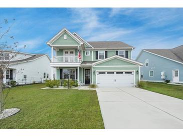 Charming two-story home boasts a spacious front yard, two car garage, and a quaint second story balcony at 641 Sienna Way, Summerville, SC 29486