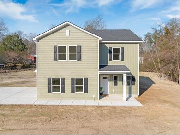 Charming two-story home with a welcoming facade and well-maintained landscaping and black shutters at 1738 N N Hwy 52, Bonneau, SC 29431