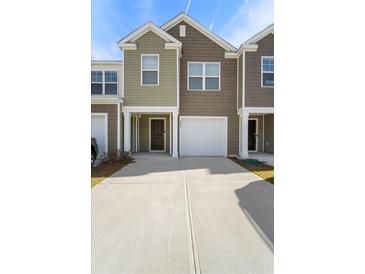 Charming townhouse featuring varied siding, a one-car garage, and a concrete driveway at 204 Cozy Brook Ct, Summerville, SC 29486