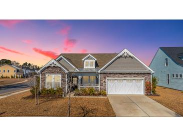 Charming single-Gathering home featuring stone accents and a welcoming front porch at sunset at 292 Lotz Dr, Summerville, SC 29483