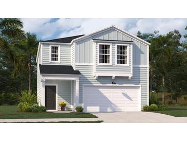 Charming two-story home with light-blue siding, white trim, a dark front door, and an attached garage at 317 Pine Crest View, Summerville, SC 29486