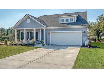 Charming home showcasing a well-manicured lawn and inviting front porch with decorative columns at 3278 Great Egret Dr, Johns Island, SC 29455