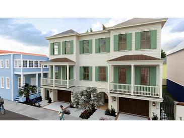 Charming townhomes with a lovely facade, green shutters, and cozy balconies over each garage at 4 Trapman St # A, Charleston, SC 29401