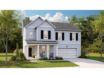 Charming two-story home featuring a well-manicured lawn, a welcoming front porch, and a two-car attached garage at 548 Richfield Way, Summerville, SC 29486