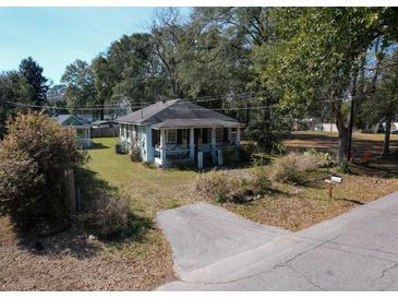 Charming single-story home with a covered porch and a well-maintained front yard at 727 Spark St, Mount Pleasant, SC 29464