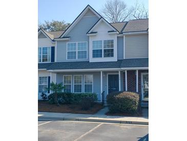 Charming two-story townhouse with light blue siding, white trim, and well-maintained landscaping at 120 Hornby Cir, Goose Creek, SC 29445