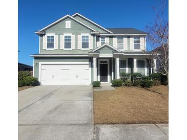 Charming two-story home with a well-manicured lawn, two car garage, and classic architectural details at 126 Shadybrook Dr, Summerville, SC 29486