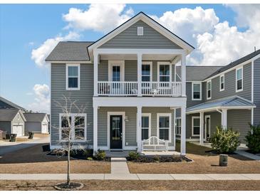 Charming two-story home with a welcoming front porch and a classic gray exterior at 127 Country Gate Ln, Summerville, SC 29485