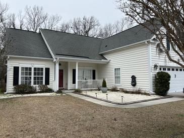 Charming single story home with white siding, black shutters and manicured lawn at 1346 Ashley Gardens Blvd, Charleston, SC 29414