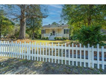 Charming home with a white picket fence and inviting front porch at 207 S Gum St, Summerville, SC 29483