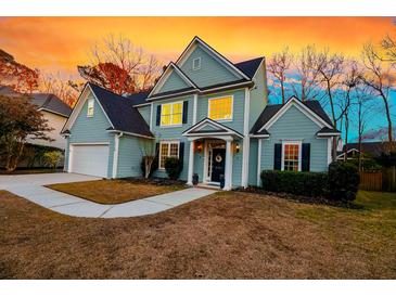 Charming two-story home features a well-manicured lawn and inviting entrance at 2124 Tall Grass Cir, Mount Pleasant, SC 29466
