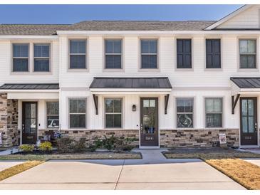 Charming townhouse with stone accents, light trim, and black door awning at 5146 Park Creek Ave, North Charleston, SC 29418