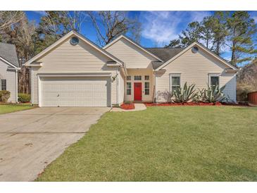 Charming home featuring a well-manicured lawn, attached garage, and bright red front door at 5420 Percival Ln, North Charleston, SC 29420