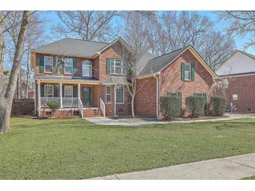 Charming two-story brick home with a well-manicured lawn and classic green shutters at 659 Hamlet Cir, Goose Creek, SC 29445