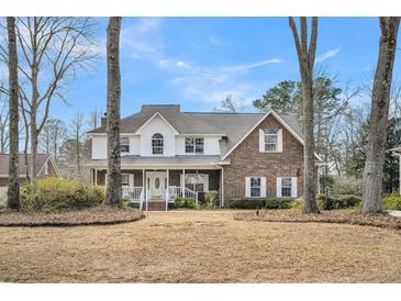 Charming brick and white two-story home with inviting front porch and well-maintained lawn at 8615 Arthur Hills Cir, North Charleston, SC 29420