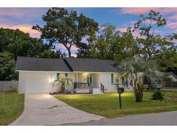 Charming, single-story home features a brick facade, dark roof, palm trees, and well-maintained lawn at 1520 Wakendaw Rd, Mount Pleasant, SC 29464
