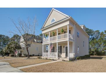 Charming two-story home with a double porch, white columns, and manicured landscaping at 1945 Hubbell Dr, Mount Pleasant, SC 29466