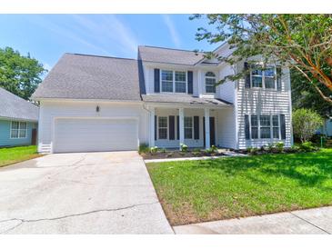 Charming two-story home with a well-manicured lawn, attached garage, and beautiful curb appeal at 506 Cecilia Cove Dr, Charleston, SC 29412