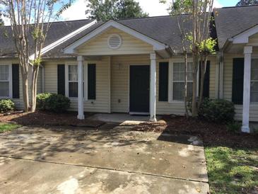 Charming single-story home with a welcoming front porch and a well-maintained yard at 7963 Weld St, North Charleston, SC 29418