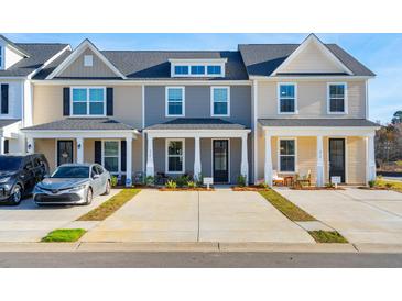 Charming townhome with a welcoming front porch and well-manicured landscaping at 814 Alma Square Dr, Moncks Corner, SC 29461