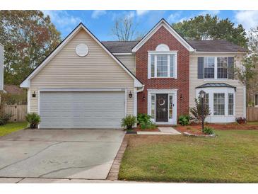 Charming two-story home with a well-maintained lawn, brick and vinyl siding, and an attached two-car garage at 105 Carter Dr, Goose Creek, SC 29445