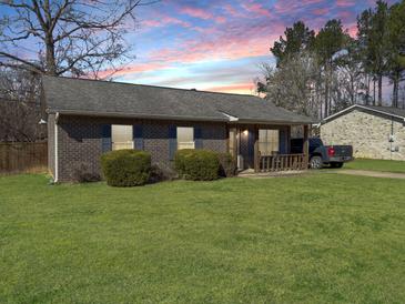 Charming brick home with a well-manicured lawn and a cozy front porch at 115 O'Carroll St, Moncks Corner, SC 29461